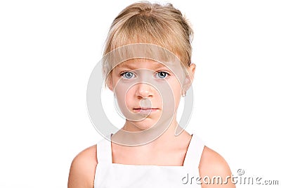 Sad little girl with serious face on white Stock Photo