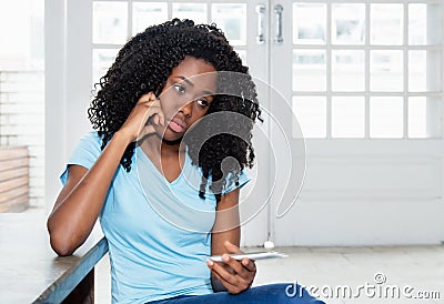 Sad and lonely african american woman waiting for message Stock Photo