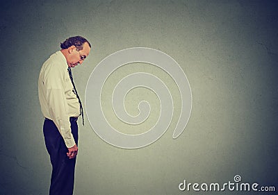 Sad lonely business man looking down has no energy motivation in life depressed Stock Photo