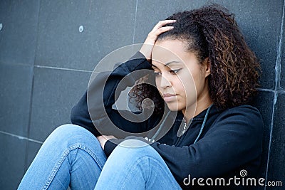 Sad and lonely teenager portrait in the city street Stock Photo