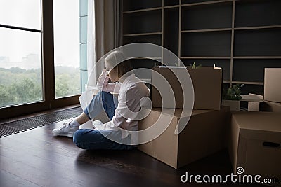 Sad lonely young renter woman moving out from home Stock Photo