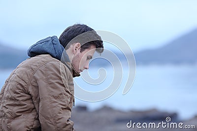 Sad man in winter on the beach complaining Stock Photo