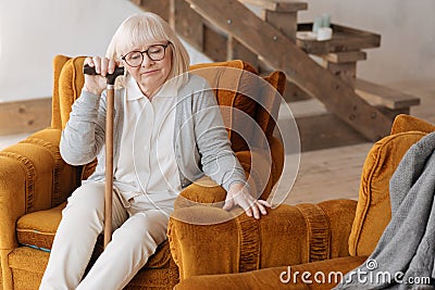 Sad moody woman sitting in the armchair Stock Photo