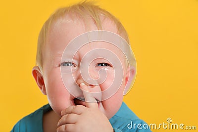 A sad and offended little child cries with tears in his eyes Stock Photo