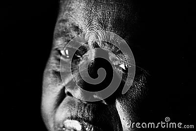 A sad old African woman looks on in despair Stock Photo