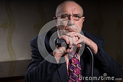 Sad Old Bald Guy with Cane Looking at the Camera Stock Photo