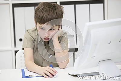 Sad schoolboy does homework. Stock Photo