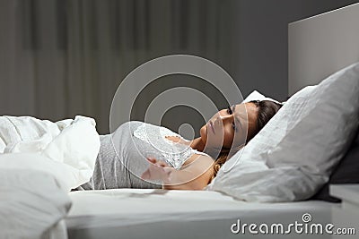 Sad single woman missing her husband in the night Stock Photo