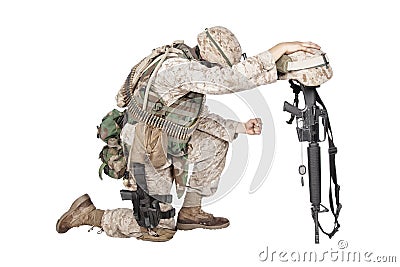 Sad soldier kneeling because of friend death Stock Photo