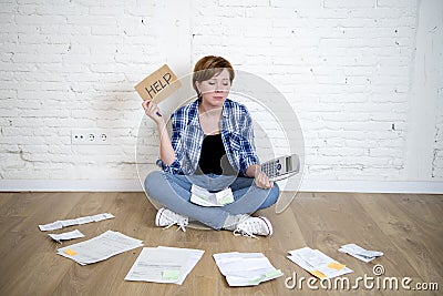 Sad stressed woman with calculator and bank and bills paperwork and documents doing domestic financial accounting Stock Photo