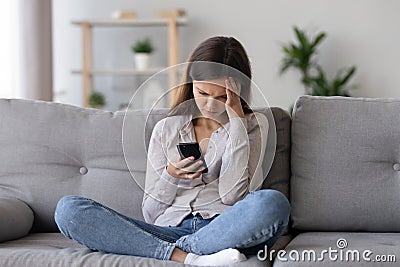 Sad teenage girl receive bad message on smartphone Stock Photo