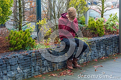 Sad teenager boy crying outdoor, covering his face with hands si Stock Photo