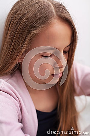 Sad teenager girl with downcast eyes - closeup portrait Stock Photo