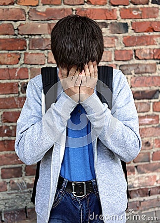 Sad Teenager by the Wall Stock Photo