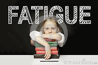 Sad Tired child with books. Fatigue concept Stock Photo