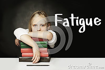 Sad Tired child girl with books. Fatigue concept Stock Photo