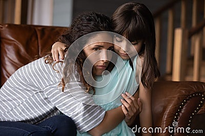 Sad unhappy Latin mom feeling depressed, frustrated, upset Stock Photo