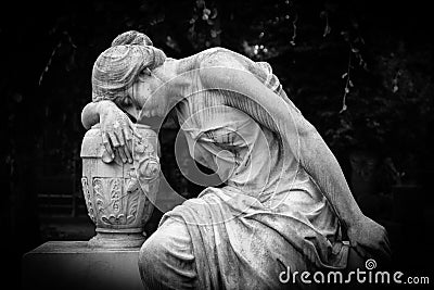 Sad and weeping woman sculpture. Sad grieving expression sculpture with sorrow face down thinking crying. Black and white BW photo Stock Photo