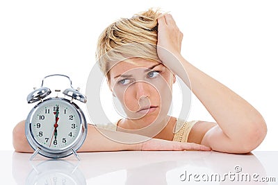 Sad woman, alarm clock and headache from alert, wakeup or deadline on a white studio background. Frustrated female Stock Photo