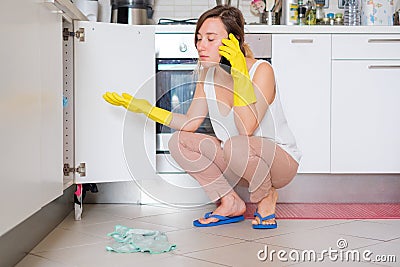 Desperate housewife calling plumber quick service Stock Photo