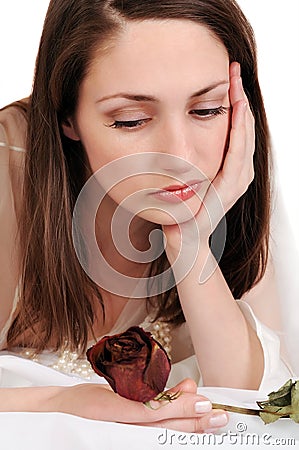 Sad woman with a faded rose. Stock Photo