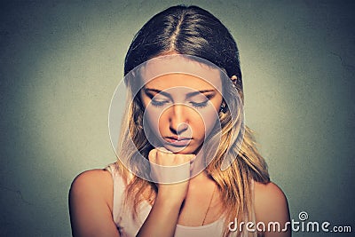 Sad woman on gray wall background Stock Photo