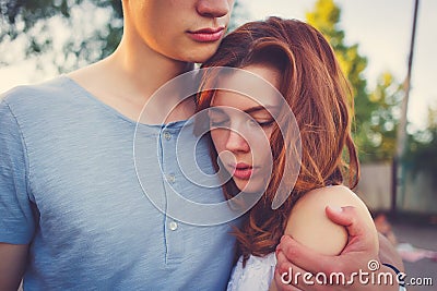 Sad woman hugging her boyfriend Stock Photo