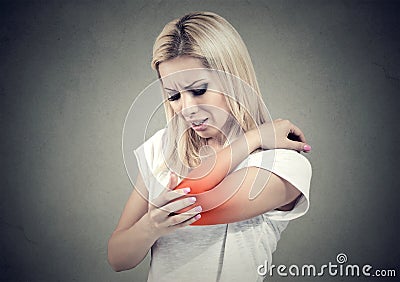 Sad woman with joint inflammation. Female`s elbow. Arm pain and injury. Stock Photo