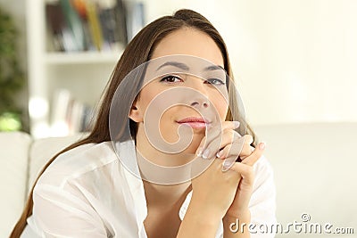 Sad woman looking at camera with watery eyes Stock Photo