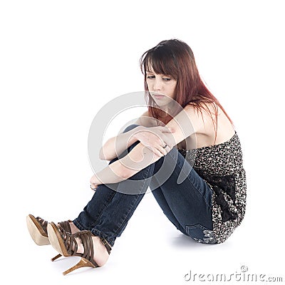 Sad Woman Sitting on the Floor Embracing her Knee Stock Photo