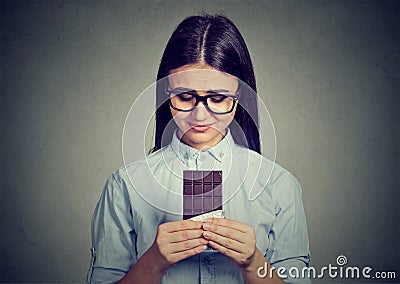 Sad woman tired of diet restrictions craving sweets chocolate bar Stock Photo