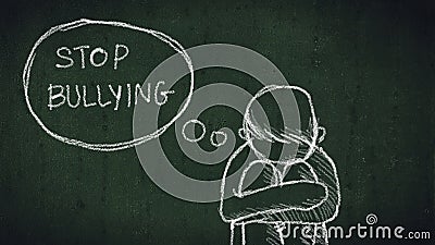 Sad young boy sitting on the floor with text stop bullying Stock Photo