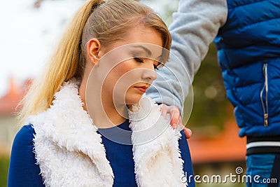 Sad young girl sit outdoors with friend. Stock Photo