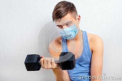 Sad Young Man with a Dumbbell Stock Photo