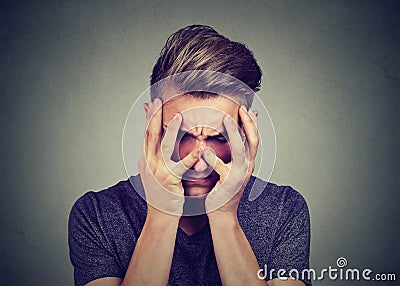 Sad young man looking down. Depression and anxiety disorder concept Stock Photo