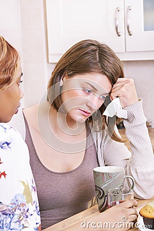 Sad young woman being comforted by friends Stock Photo