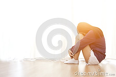Sad young woman sit in her room and covering Stock Photo