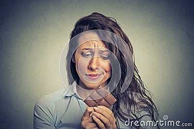 Sad young woman tired of diet restrictions craving sweets chocolate Stock Photo