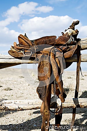 Saddle on rural fence Stock Photo