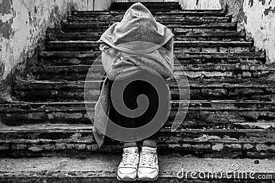 Sadness girl sitting on stairs Stock Photo