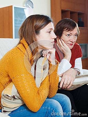 Sadness mature woman and unhappy adult daughter Stock Photo