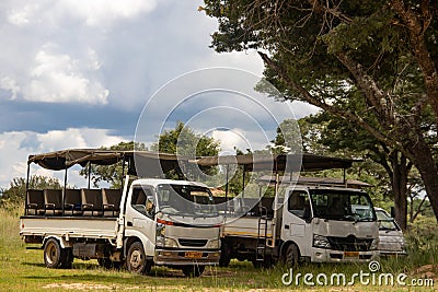 Safari open vehicle parked in deep shade under the tree Editorial Stock Photo