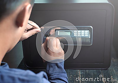 Safe break-in, dark colors. Lock opening. Security, home protection, risk minimizing concepts Stock Photo