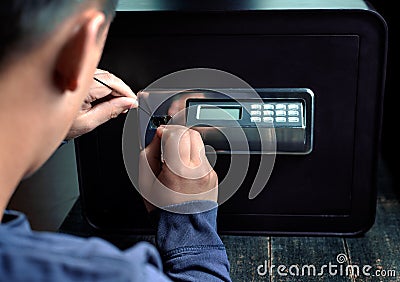 Safe break-in, dark colors. Lock opening. Security, home protection, risk minimizing concepts Stock Photo