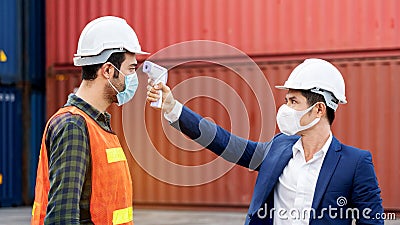 Safety of engineering team or foreman Have a helmet, Body thermometer to healthy while working and mask in factory or container. Stock Photo