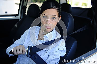 Safety: female driver fastening seat belt Stock Photo