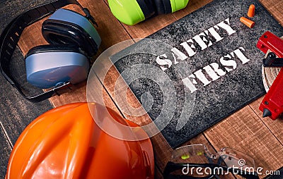 Safety first sign with personal protective equipment Stock Photo