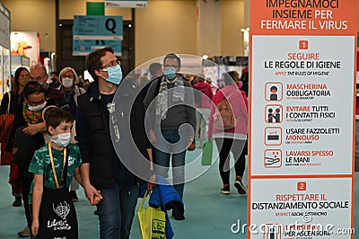 Safety guidelines billboard message on display at crowded fair place Editorial Stock Photo