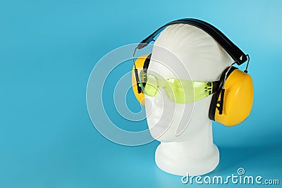 Safety headphones protection of hearing from noise, protective glasses, head of mannequin Stock Photo