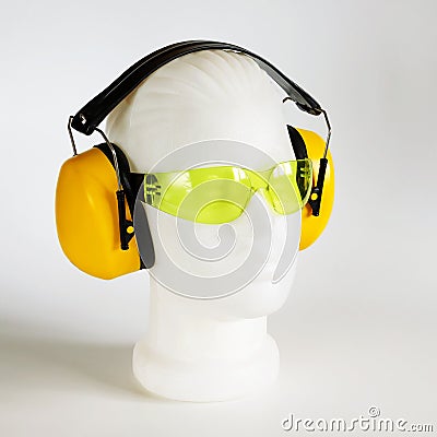 Safety headphones protection of hearing from noise, protective glasses, head of mannequin close-up Stock Photo